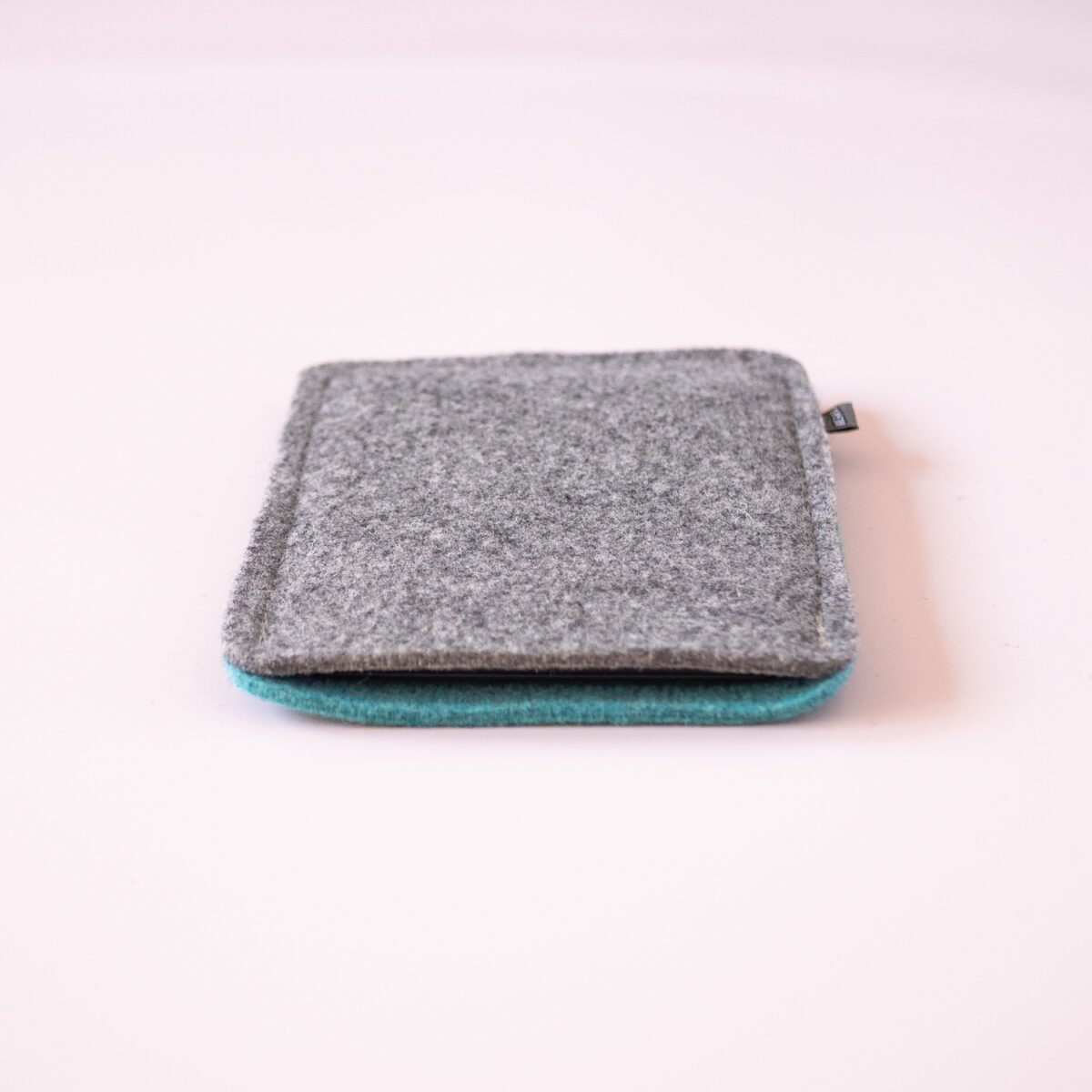 Kindle case made of turquoise blue and dark gray wool felt