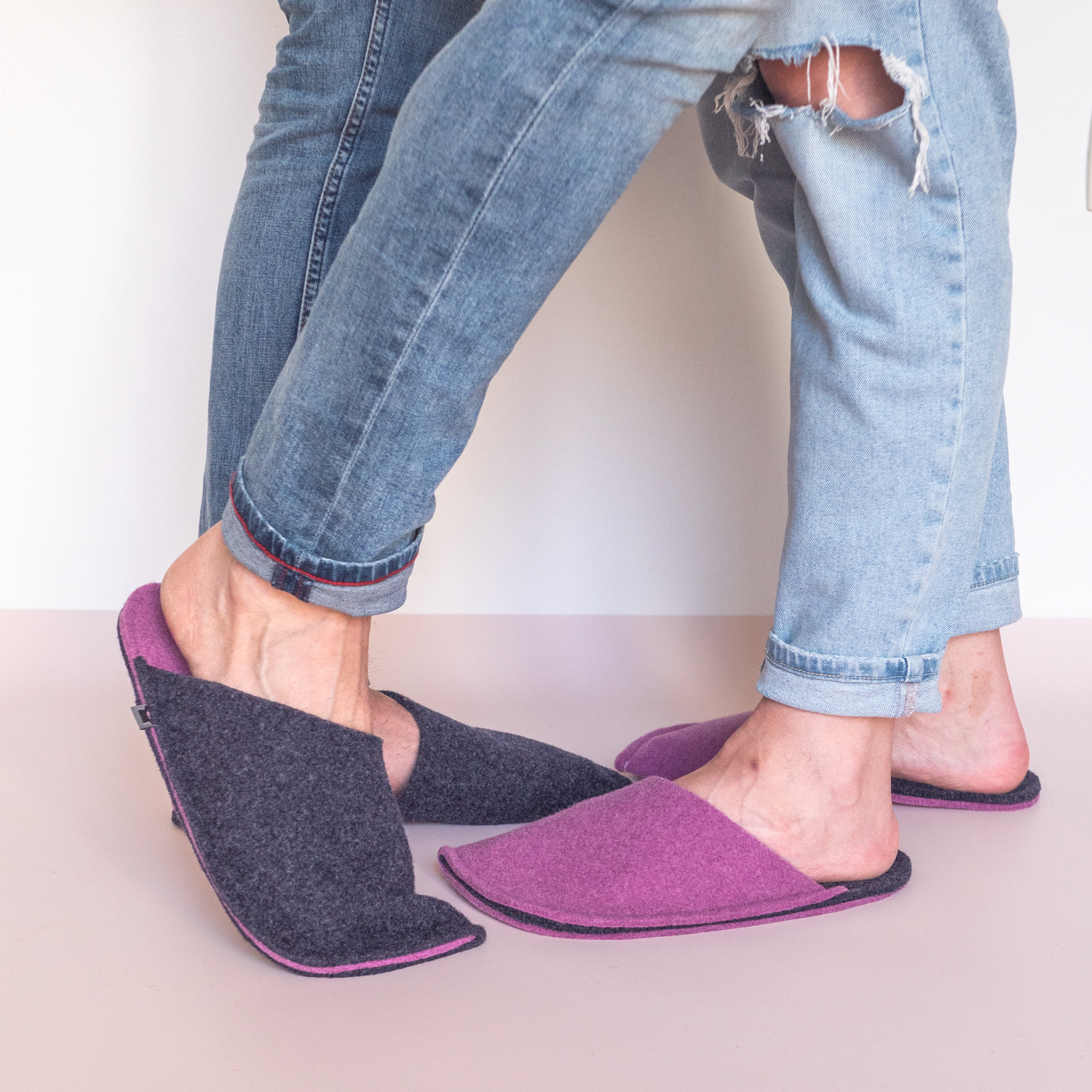 A couple wearing orchid purple and navy blue slippers