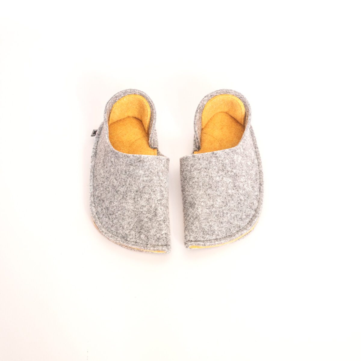 Light gray and peach yellow slippers with a closed back