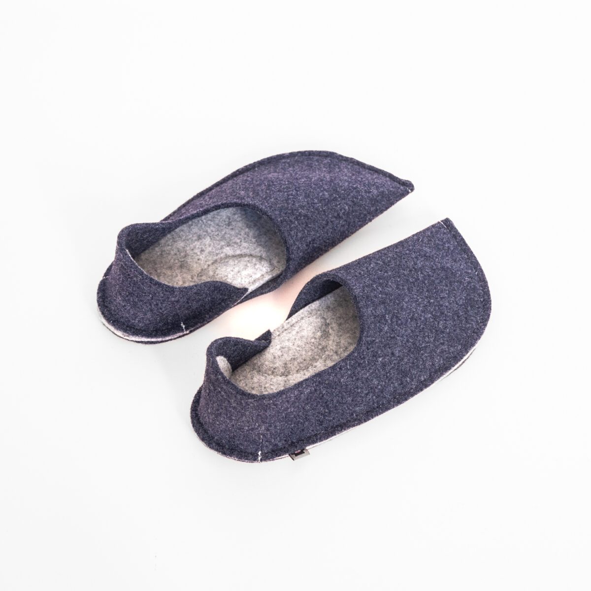 Navy blue and light gray slippers with a closed back