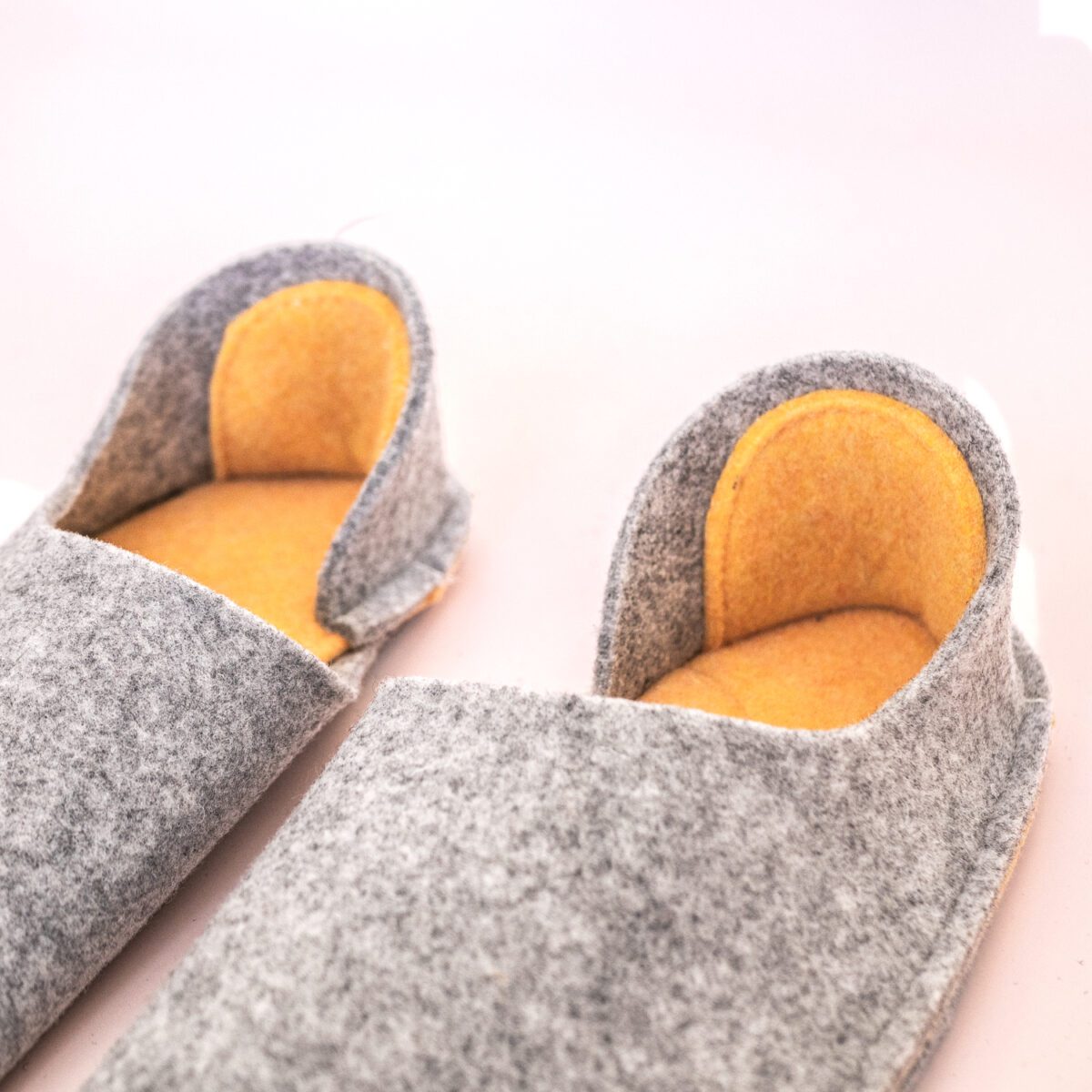 Light gray and peach yellow slippers with a closed back